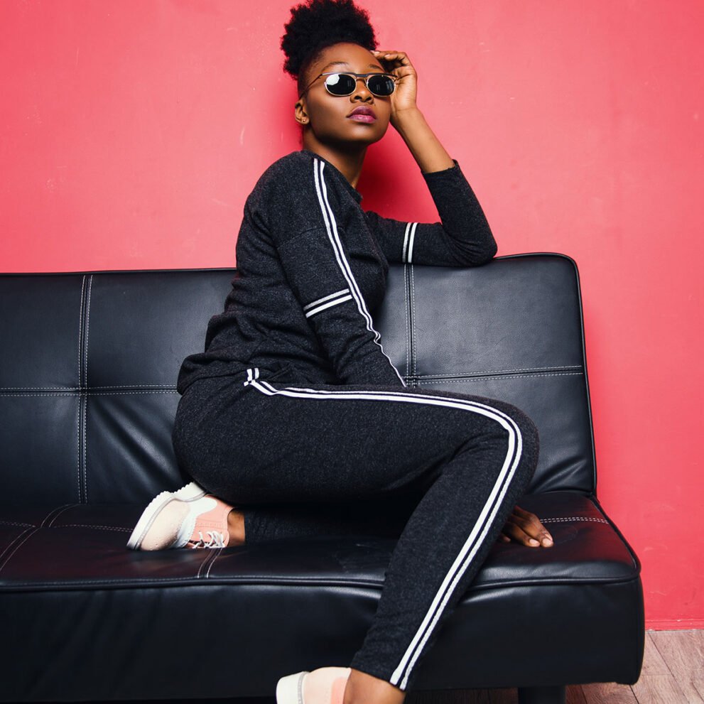 woman wearing sunglasses sits on sofa inside the room 965918